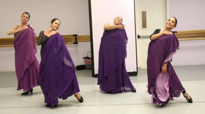 Adult ballet dancers performing together in class