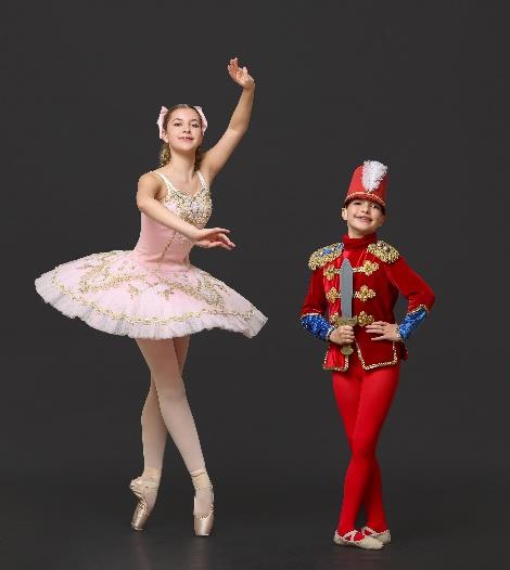 Ballet student and Nutcracker soldier performing together